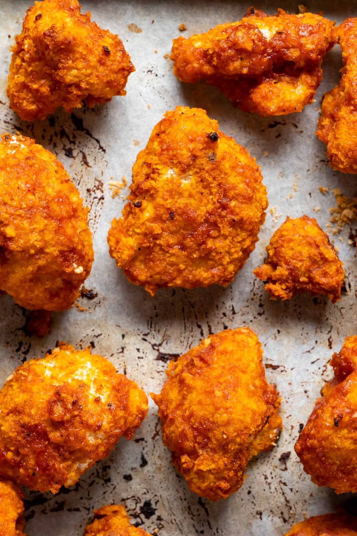 BBQ cauliflower wings on a parchment lined baking sheet.