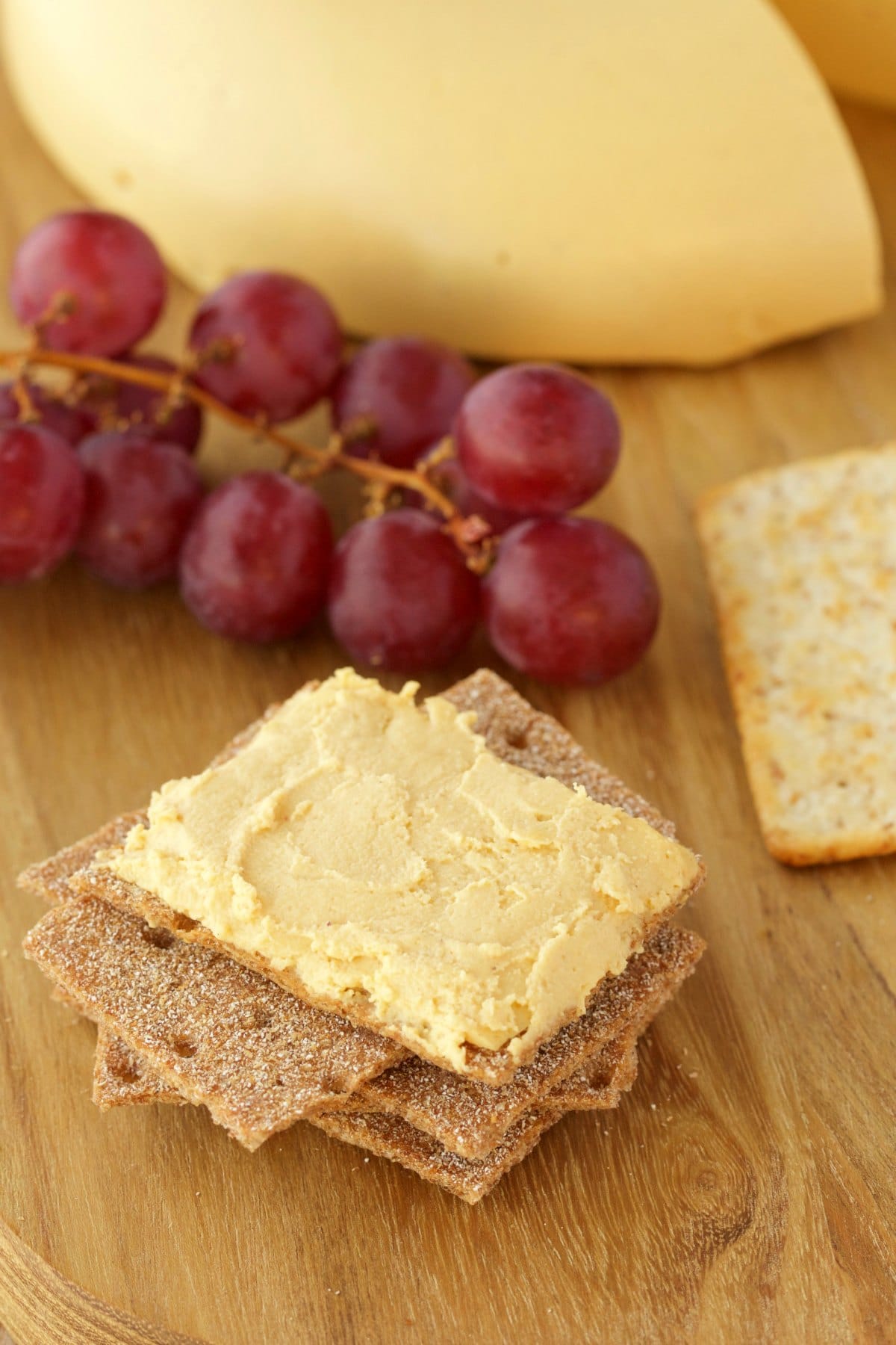 Vegan cheese mashed up on a cracker. 