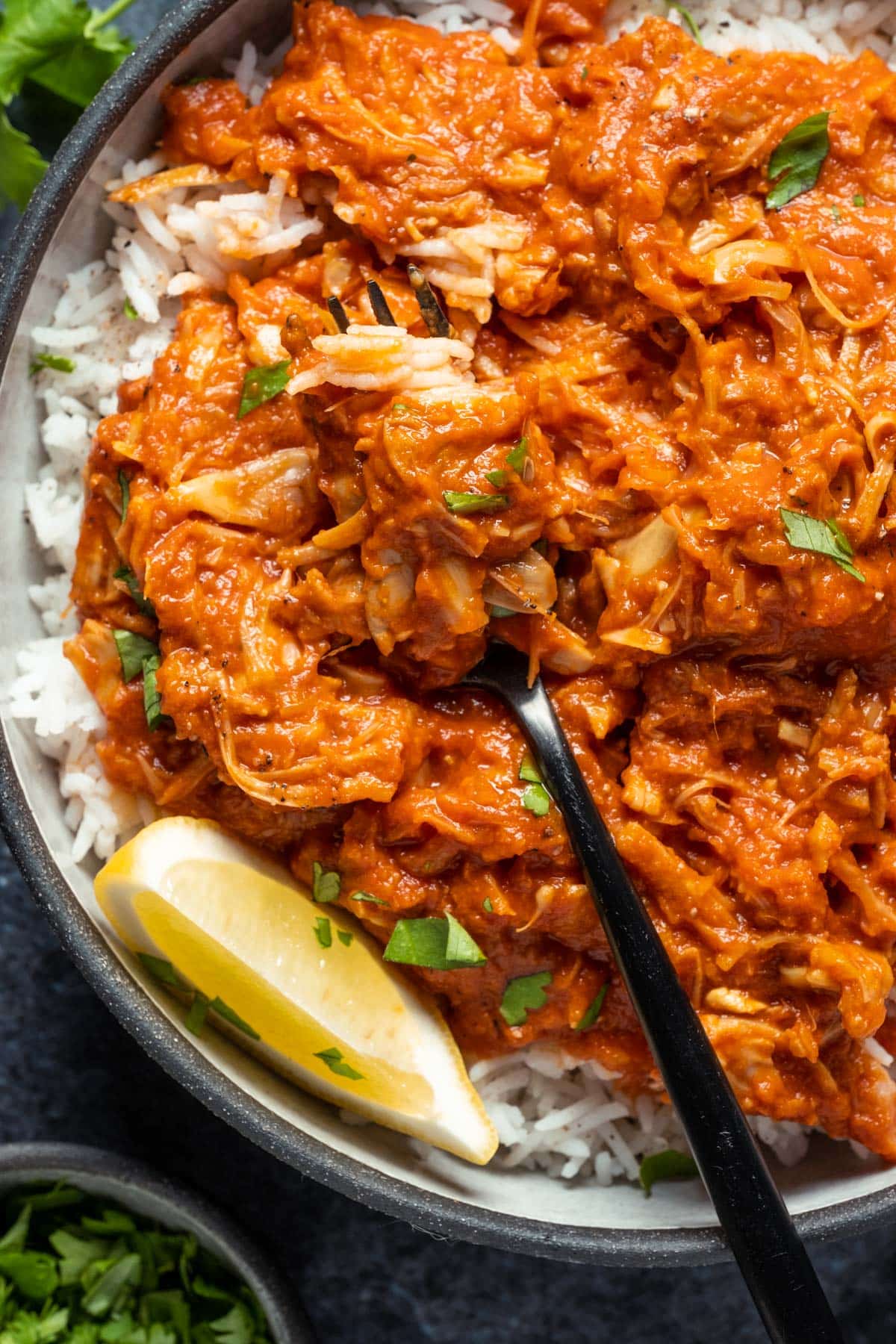 Jackfruit curry with rice in a bowl with a fork.