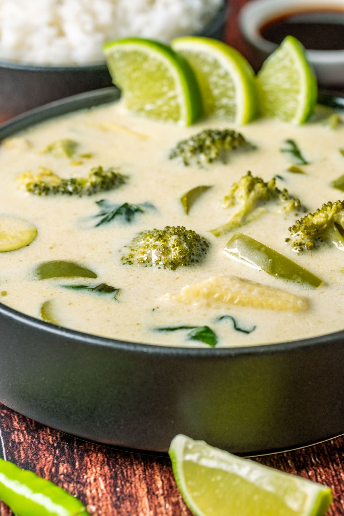 Vegan Thai green curry in a black bowl.