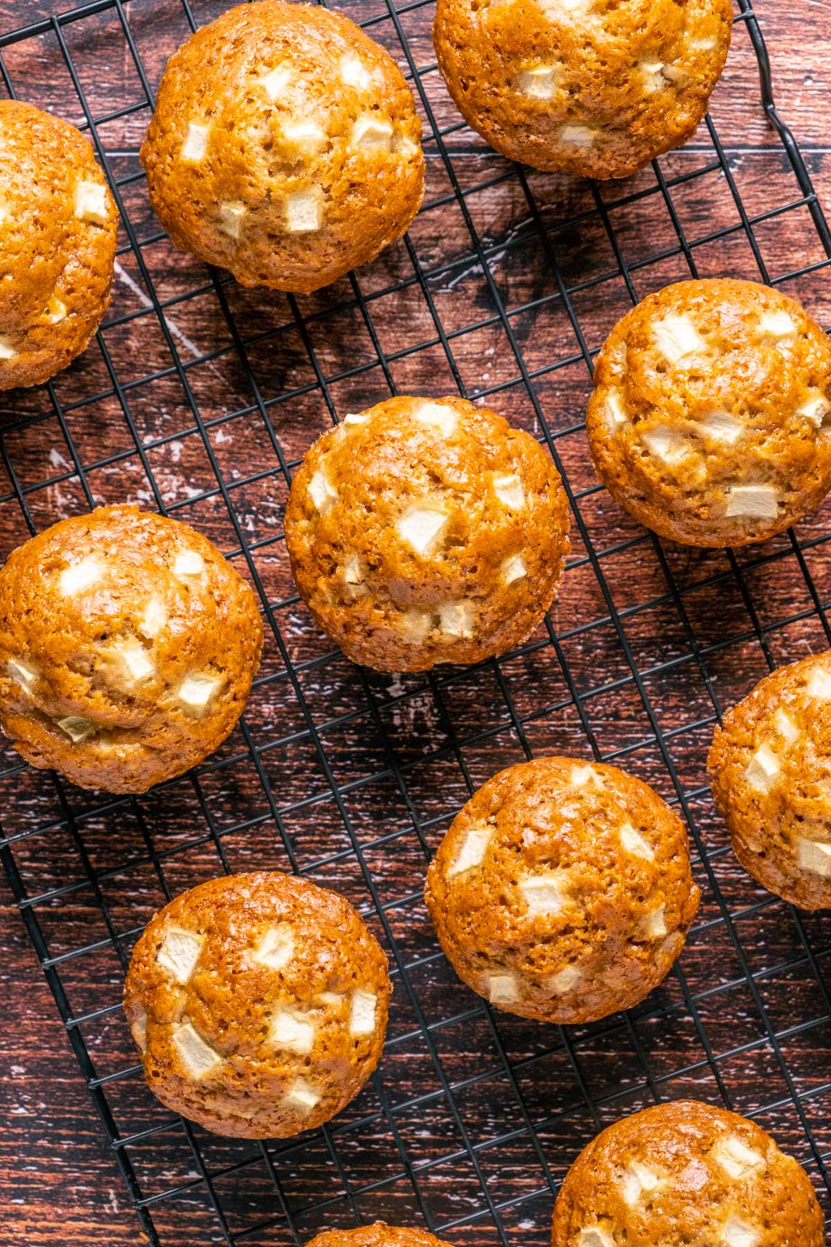 Vegan apple muffins on a wire cooling rack.