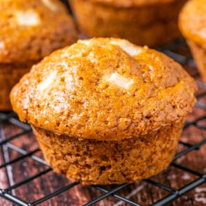 Vegan apple muffins on a wire cooling rack.