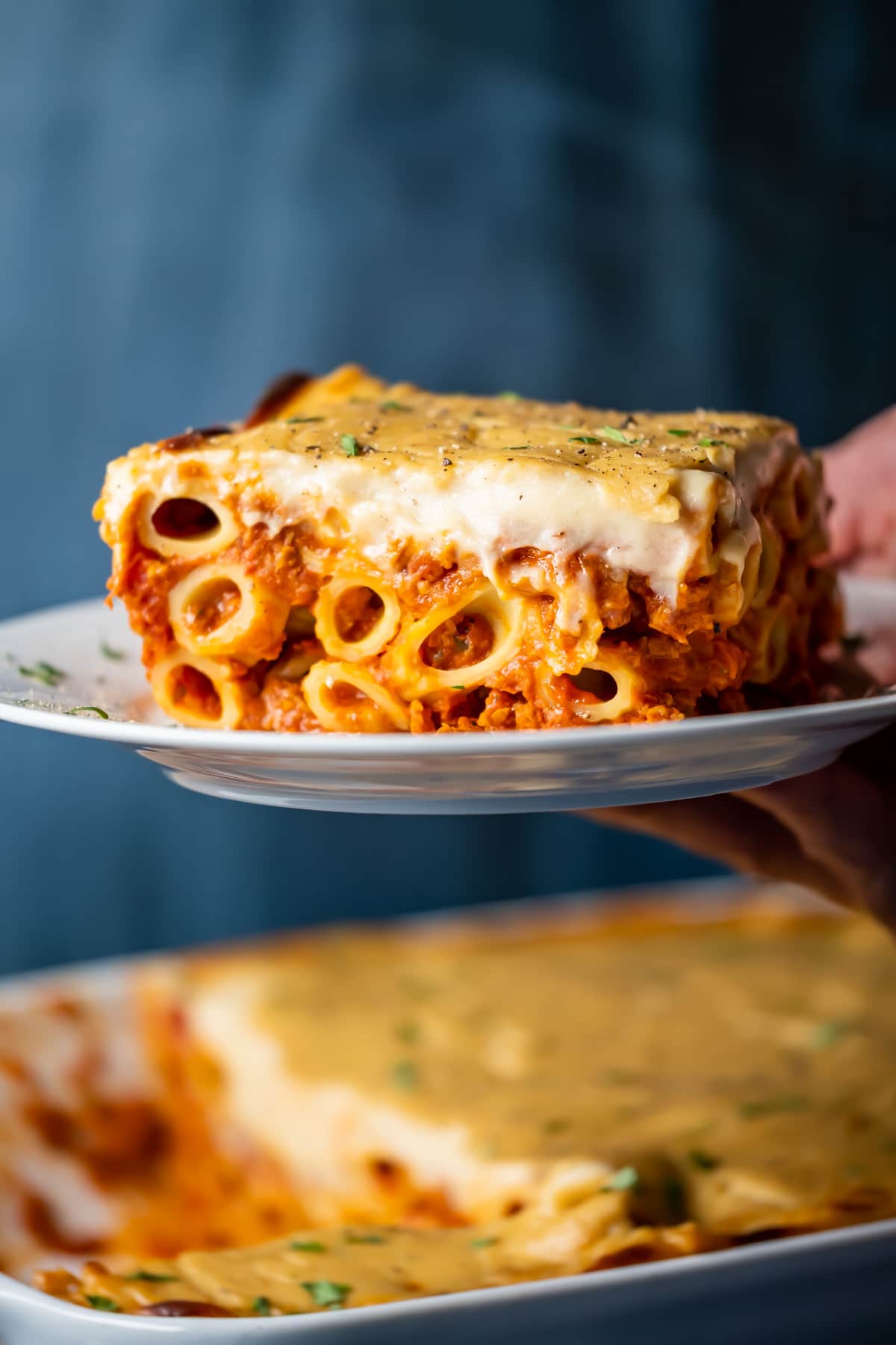 Slice of vegan baked ziti on a white plate.