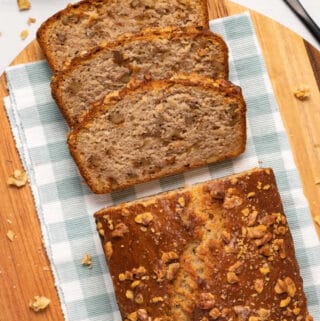 Sliced vegan banana bread on a cutting board