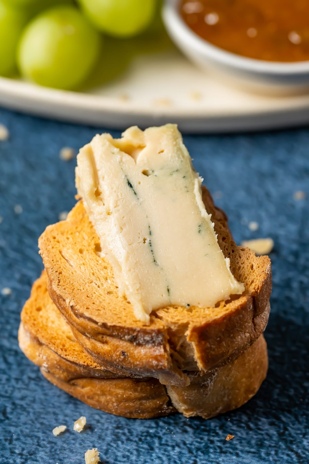 Slice of vegan blue cheese on toasted bread.