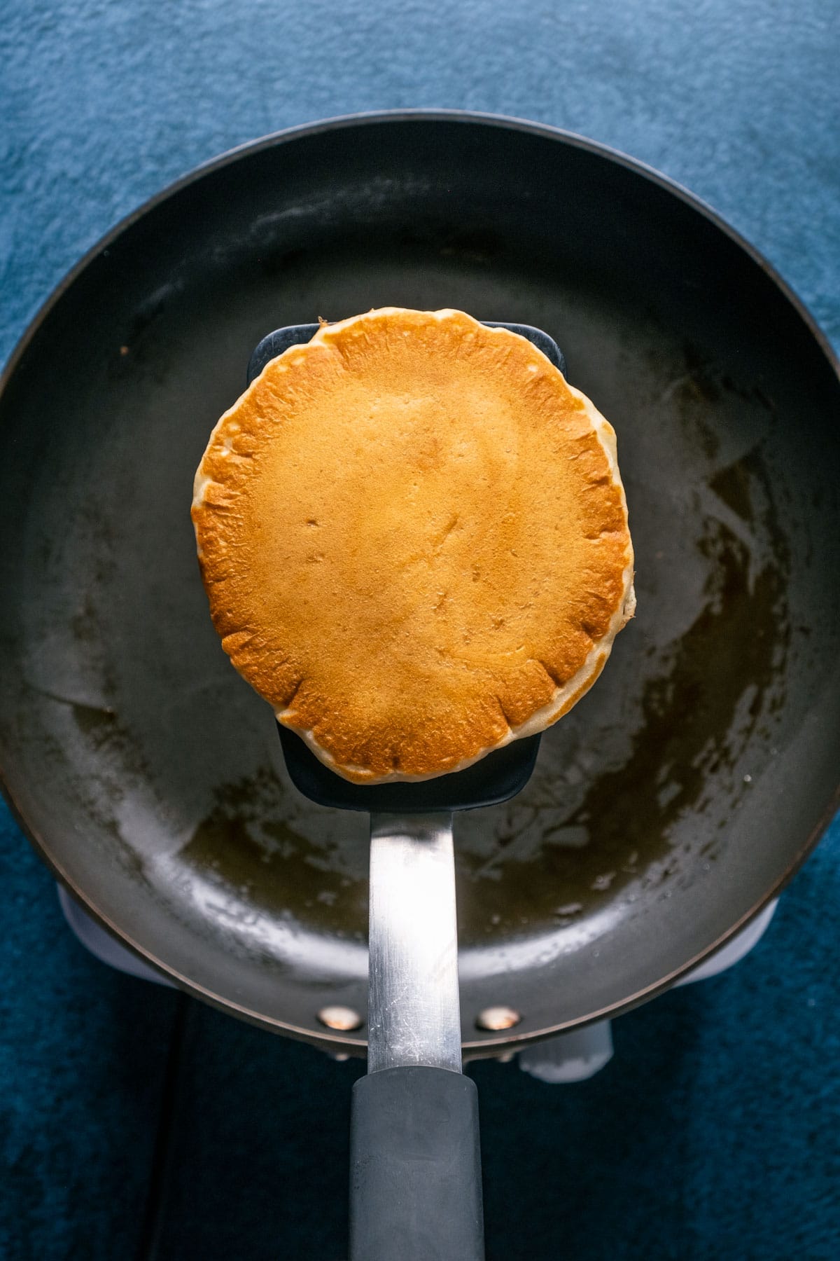 Cooked pancake on a spatula.