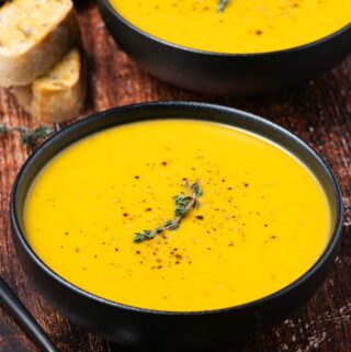 Vegan butternut squash soup in black bowls.