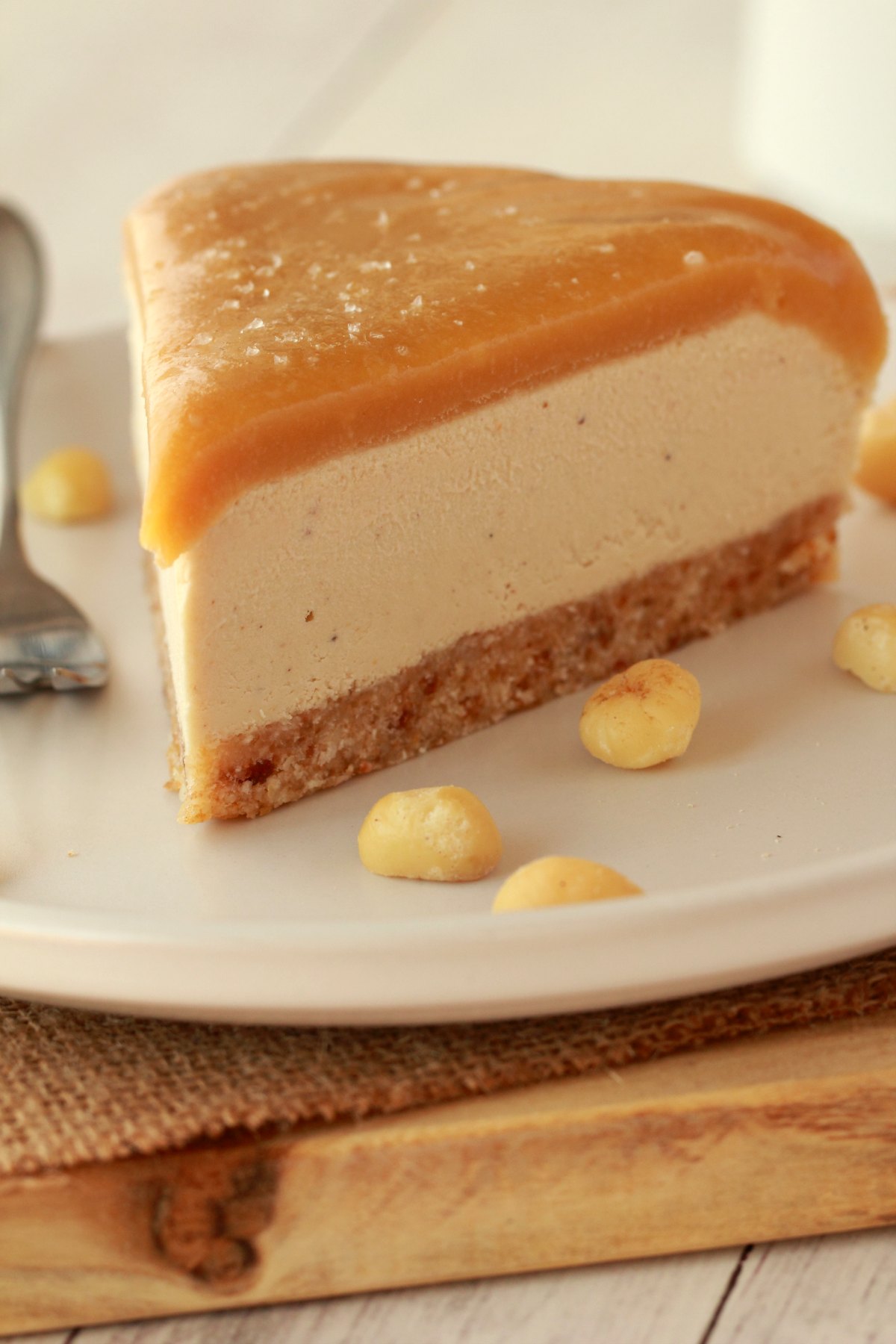 Slice of cheesecake on a white plate with a cake fork.