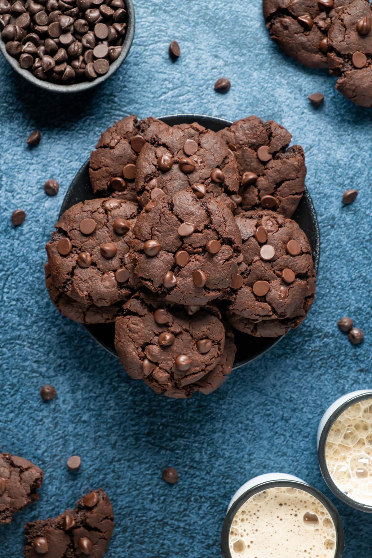 Chocolate cookies stacked up on a black plate.