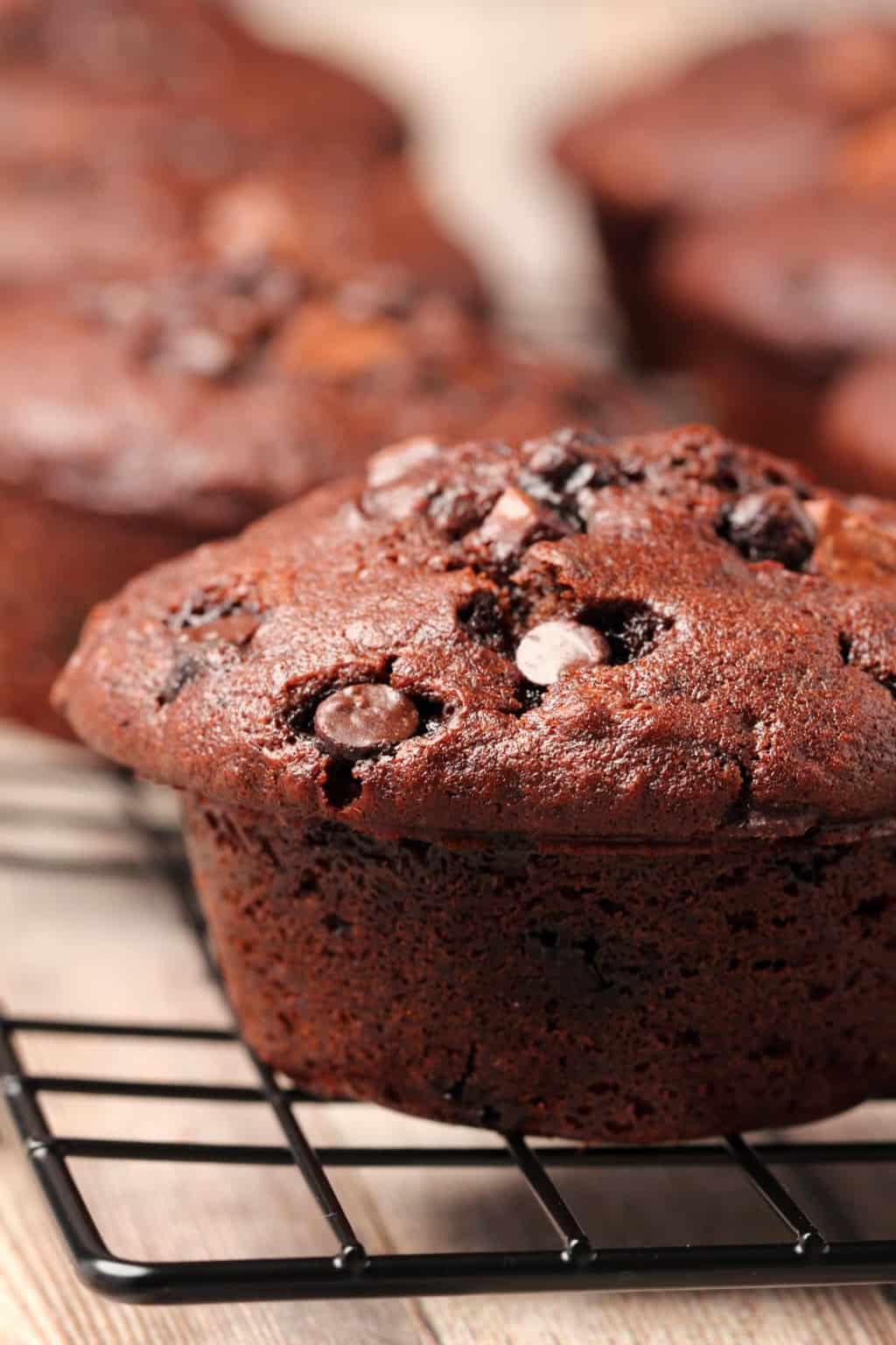 Chocolate muffins on a wire cooling rack. 