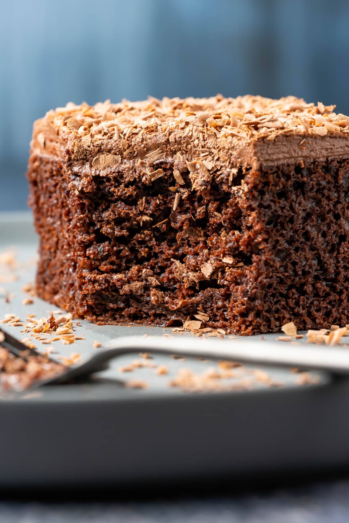 Slice of vegan chocolate sheet cake on a plate with a cake fork.