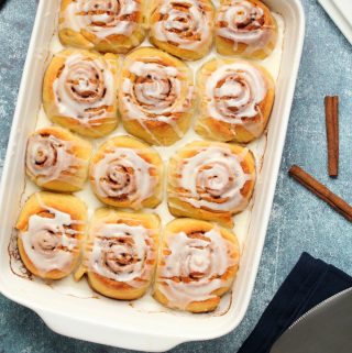 Vegan cinnamon rolls in a white dish.