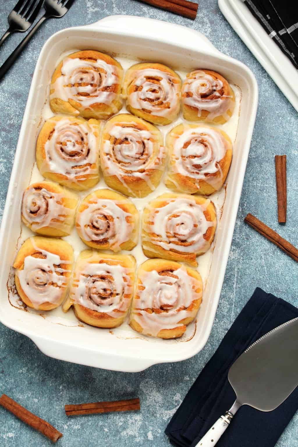 Vegan cinnamon rolls in a white baking dish. 