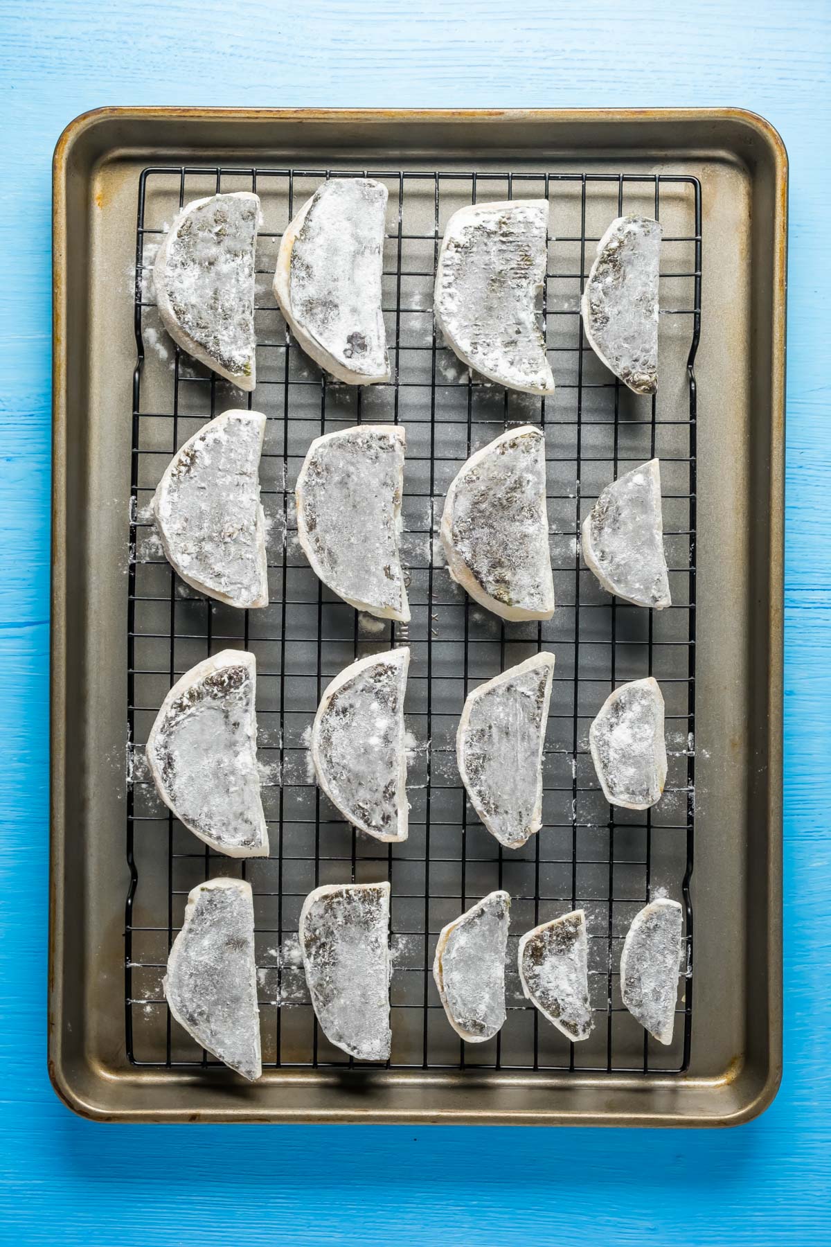 Celeriac and seaweed pieces dusted with rice flour on a wire rack.