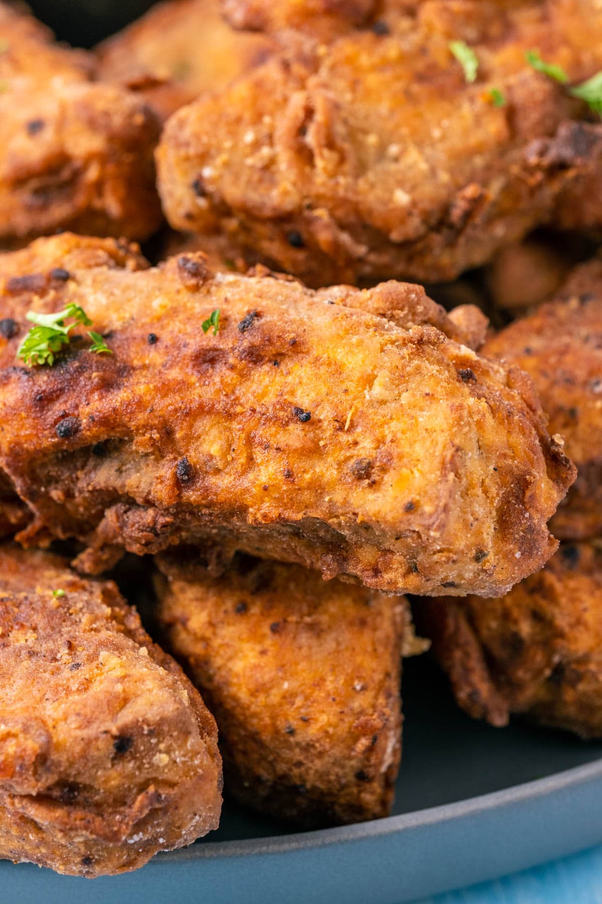 Vegan fried chicken pieces on a plate with vegan ranch dressing and chips.