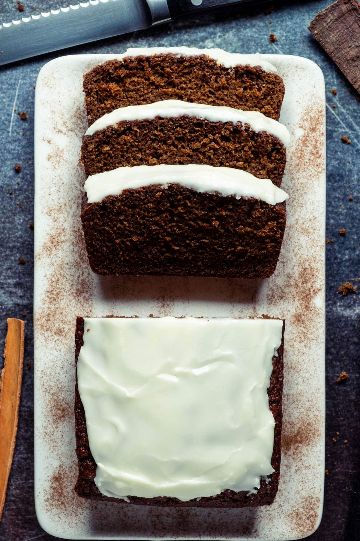 Sliced vegan gingerbread loaf on a white plate. 