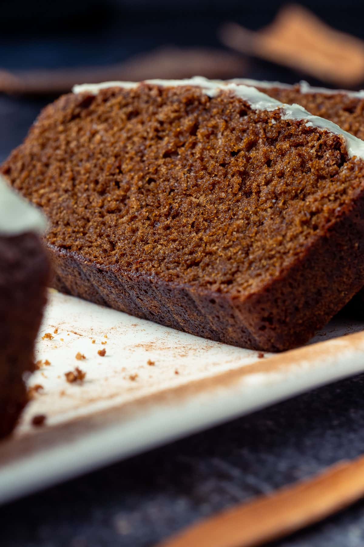 Slices of gingerbread loaf on a white plate.