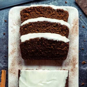 Sliced vegan gingerbread loaf on a white plate.