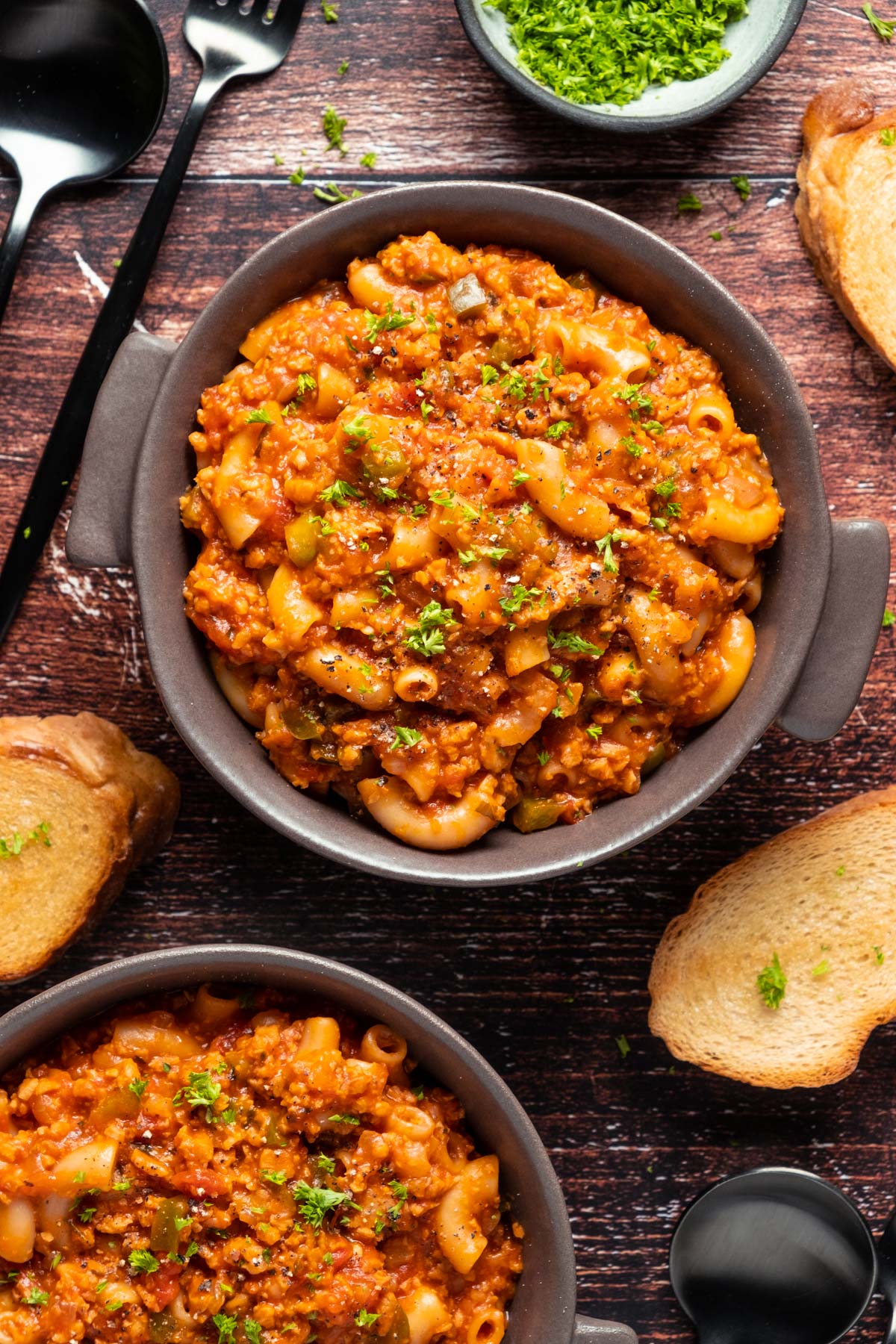 Vegan goulash n bowls topped with fresh chopped parsley. 