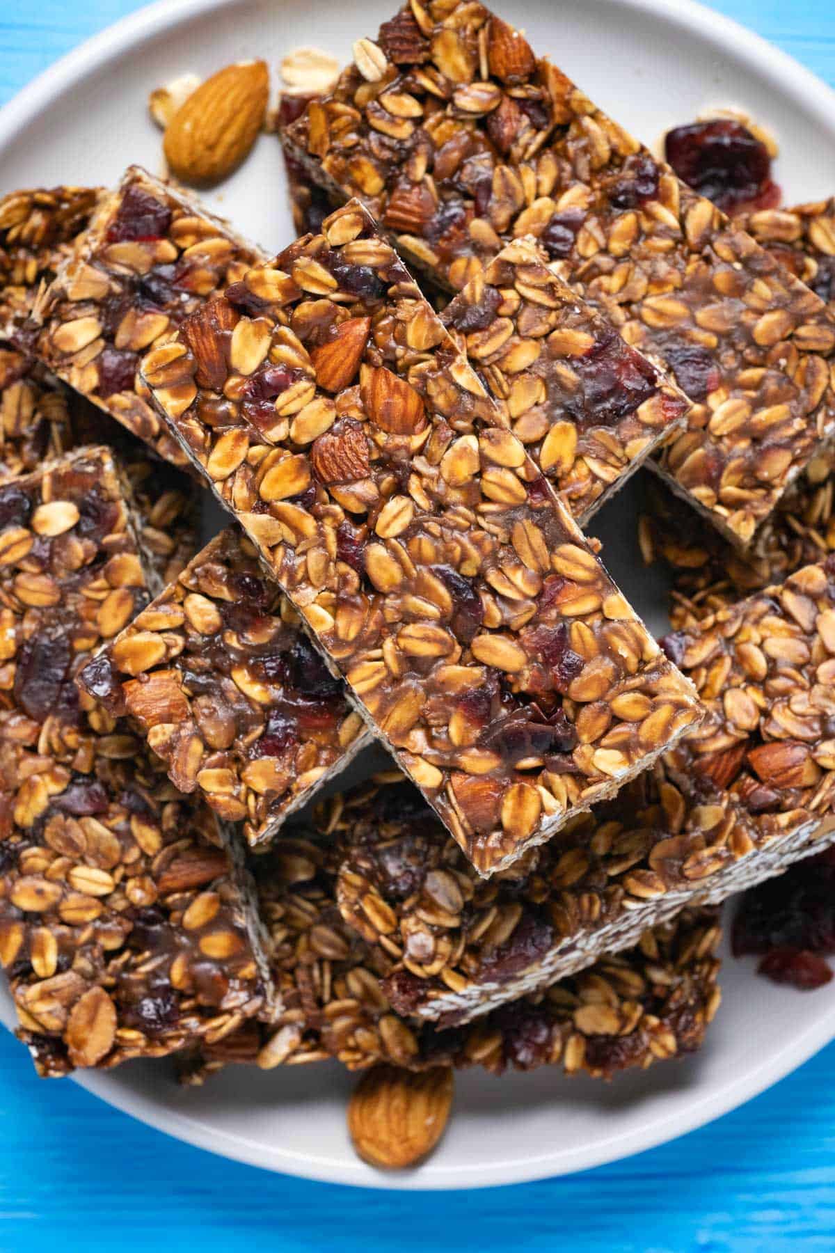 Breakfast bars stacked up on a white plate. 