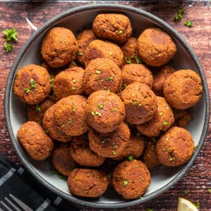 Stack of vegan meatballs on a gray plate.