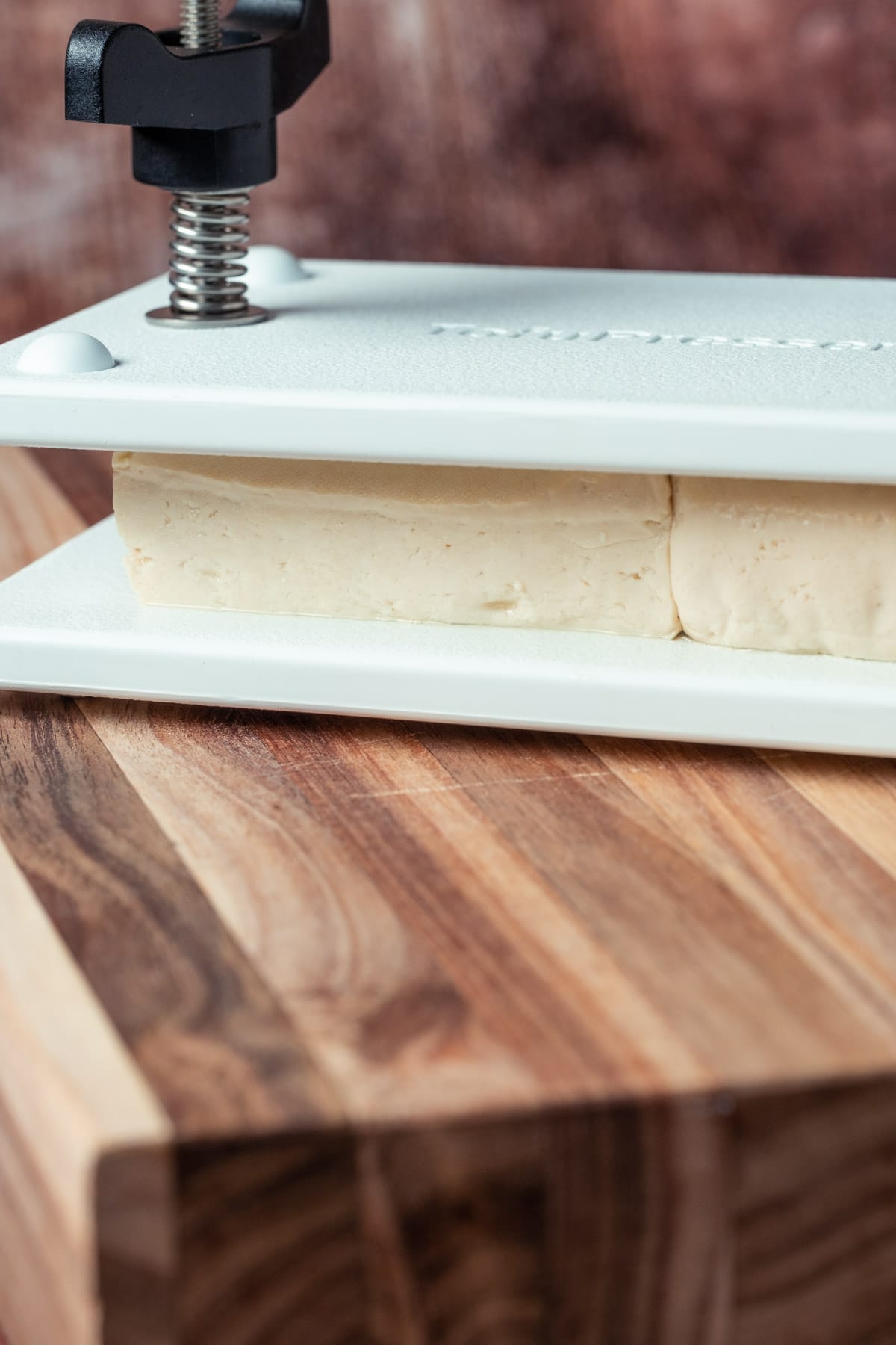 Tofu pressing in a tofu press.