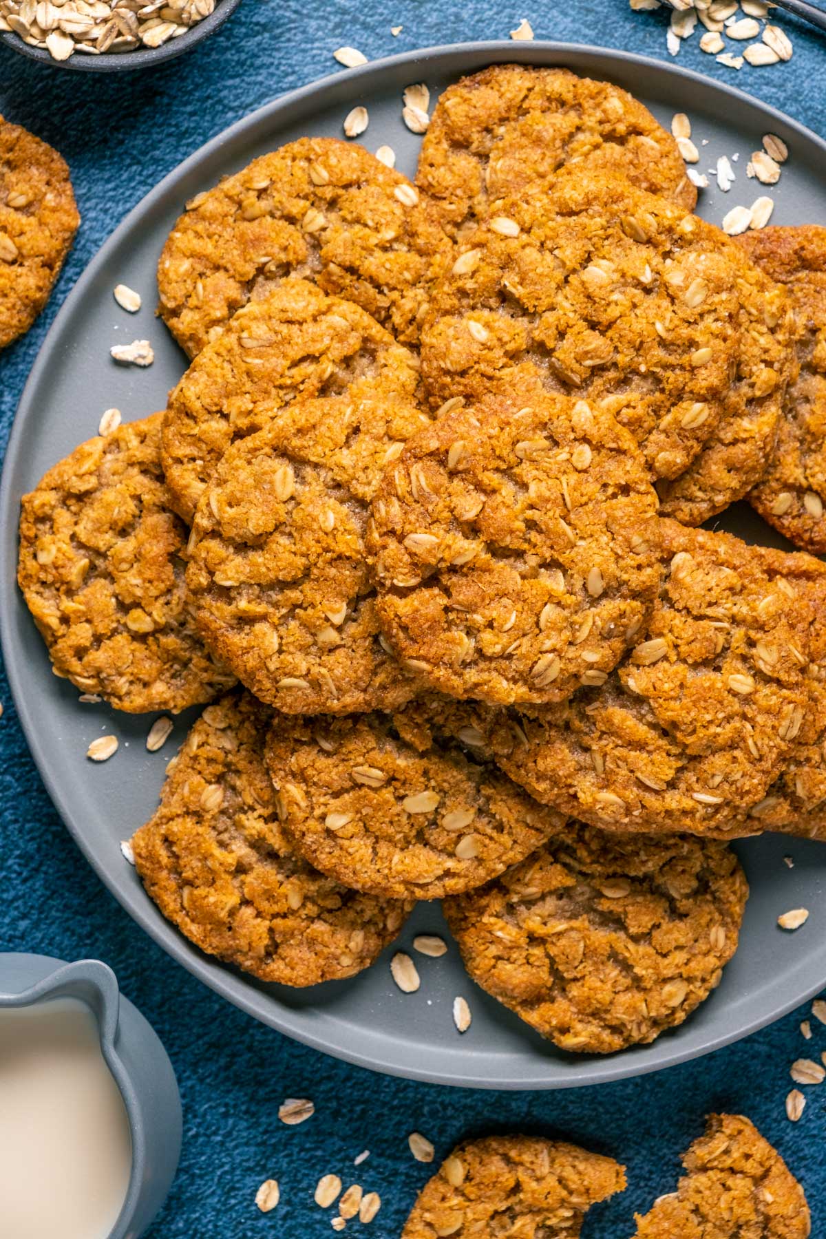 Vegan oatmeal cookies stacked up on a blue plate. 