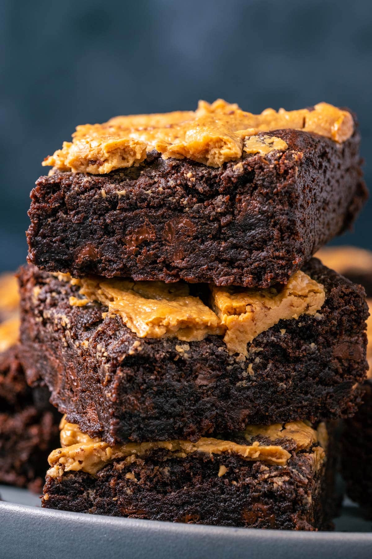 Stack of brownies on a plate.