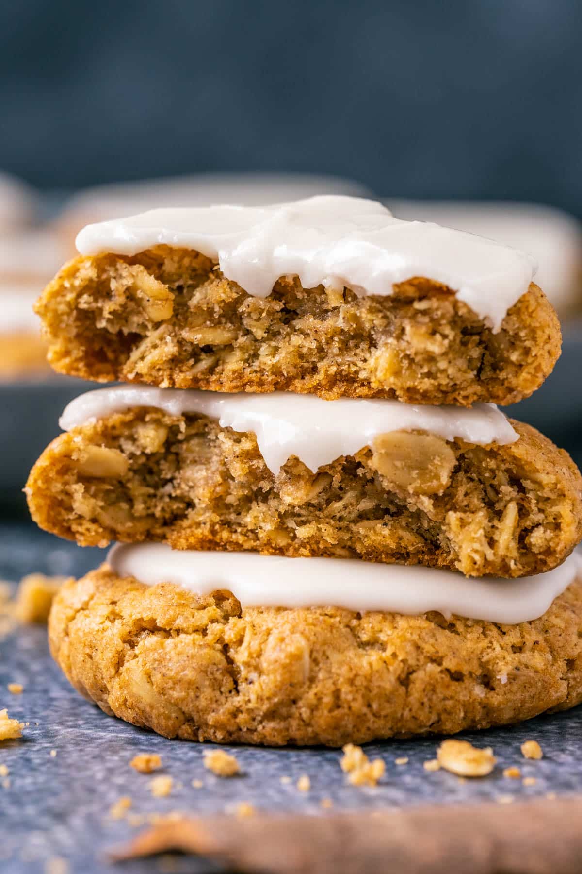 Vegan pumpkin oatmeal cookies in a stack with the top cookie broken in half.