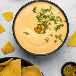 Vegan queso in a black bowl.