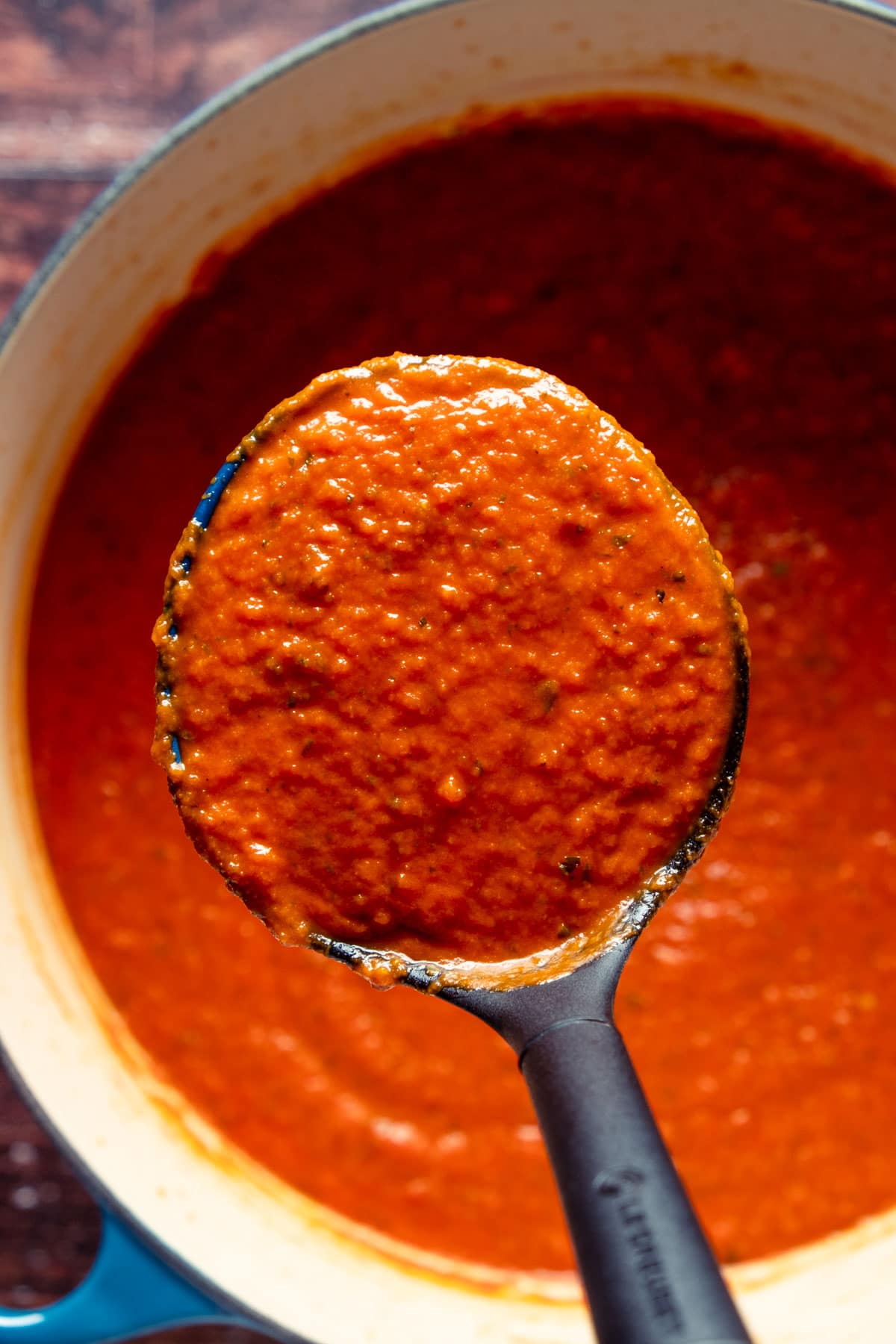 Vegan spaghetti sauce in a pot with a spoon.