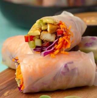 Vegan summer rolls on a wooden board.