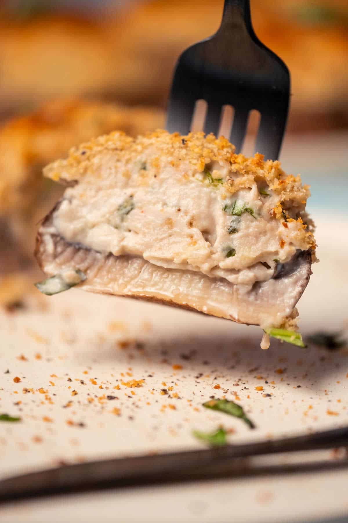 Half a stuffed mushroom on a fork.