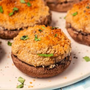 Vegan stuffed mushrooms on a white plate.